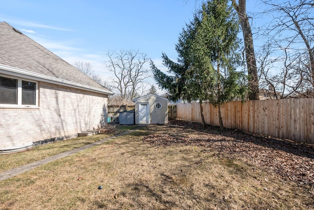 view of yard with a storage unit, fence private yard, and an outdoor structure