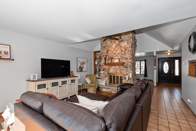 living room featuring light tile patterned floors, a stone fireplace, baseboards, and vaulted ceiling