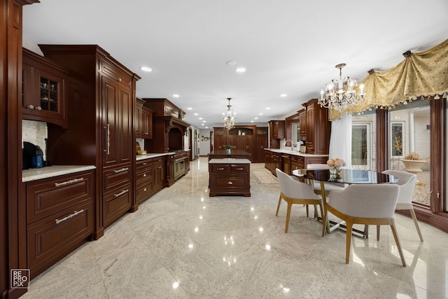 kitchen with an inviting chandelier, light countertops, pendant lighting, a sink, and recessed lighting