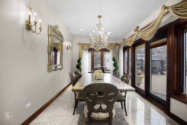 dining area featuring baseboards and an inviting chandelier