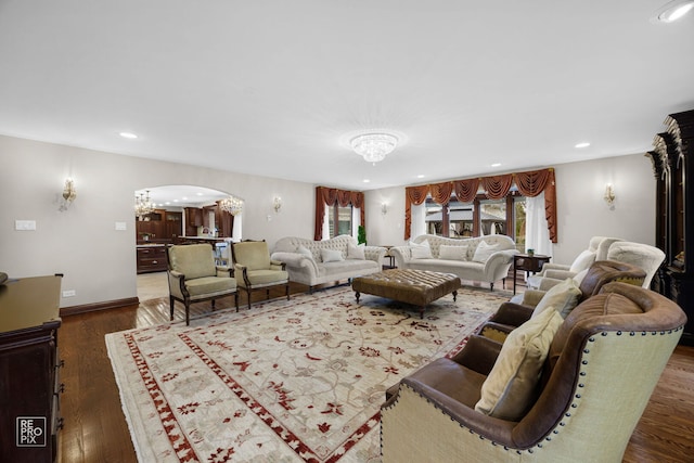 living room with a chandelier, arched walkways, recessed lighting, and wood finished floors