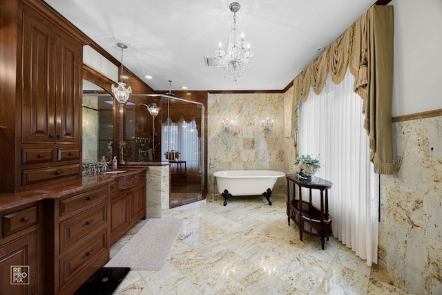 full bathroom with vanity, tile walls, a freestanding bath, a stall shower, and an inviting chandelier