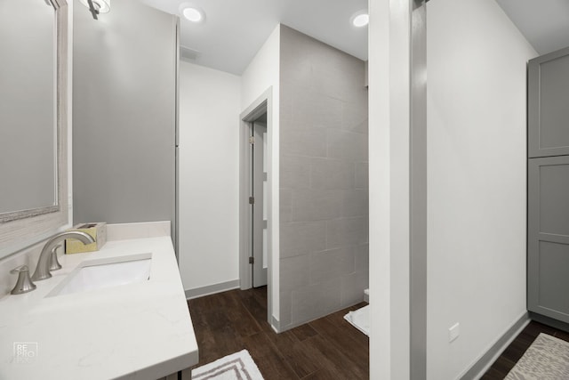 full bathroom with recessed lighting, wood finished floors, vanity, visible vents, and baseboards