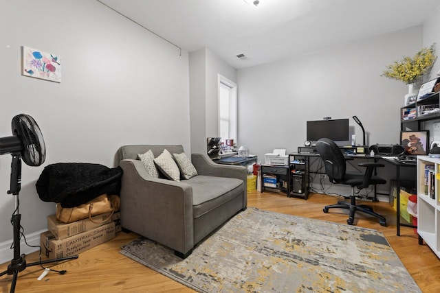 office space with wood finished floors and visible vents