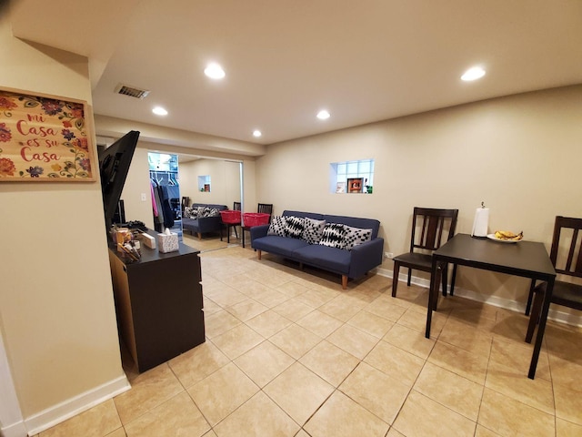 living room featuring light tile patterned floors, visible vents, and recessed lighting