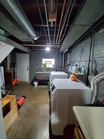 below grade area with separate washer and dryer and a sink