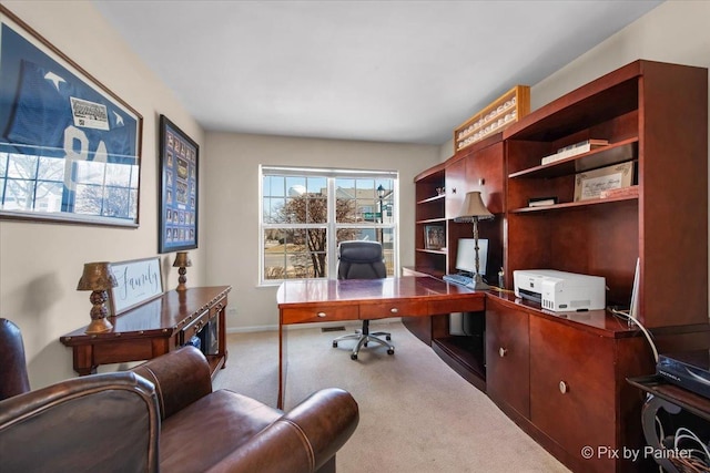 carpeted home office featuring baseboards