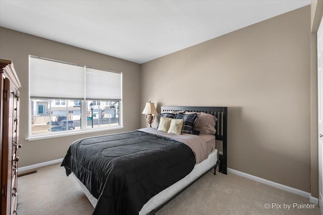 carpeted bedroom featuring visible vents and baseboards