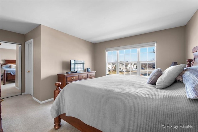 bedroom featuring baseboards and light carpet