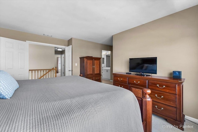 bedroom featuring visible vents and connected bathroom