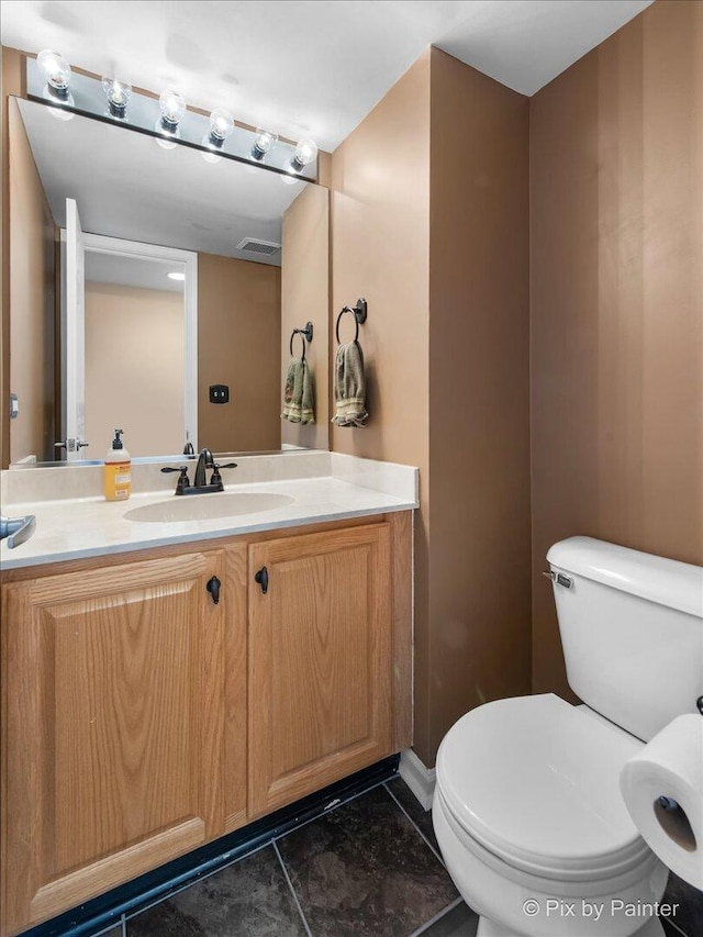 half bathroom featuring toilet and vanity