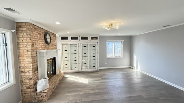 unfurnished living room featuring baseboards, visible vents, and ornamental molding