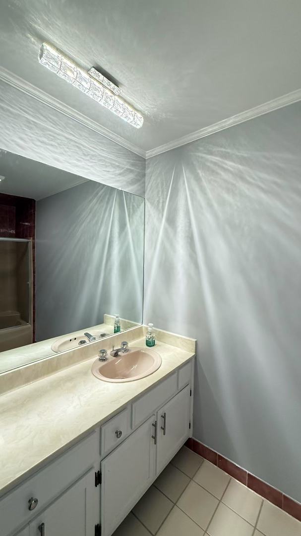 bathroom featuring vanity, baseboards, and tile patterned floors