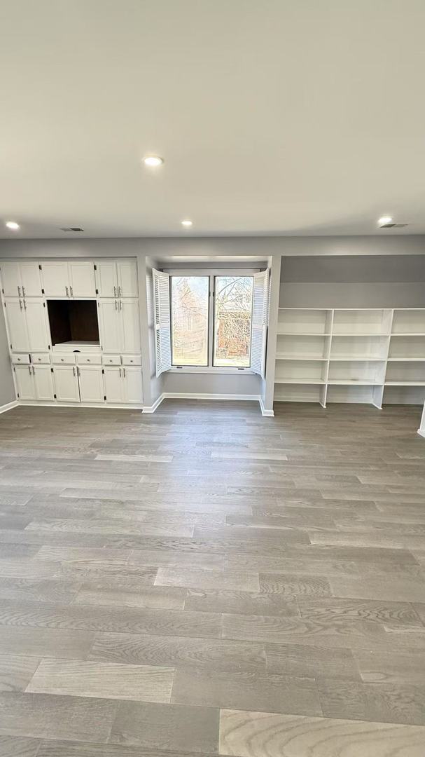 unfurnished living room featuring recessed lighting, visible vents, baseboards, and wood finished floors