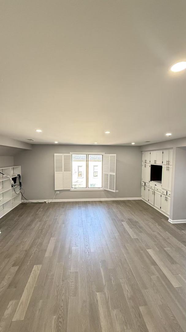 unfurnished living room featuring recessed lighting, dark wood finished floors, and baseboards