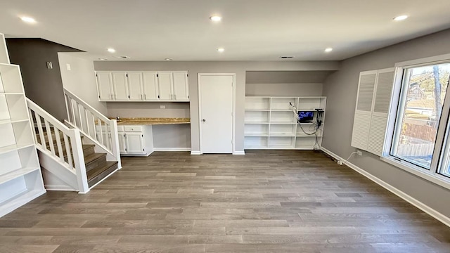 interior space featuring baseboards, dark wood-style flooring, and recessed lighting