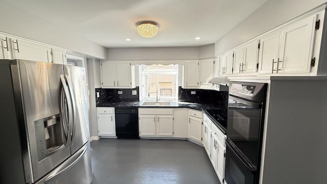 kitchen featuring black dishwasher, a sink, stainless steel fridge, and white cabinetry