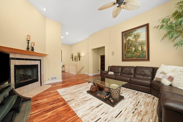 living area featuring visible vents, baseboards, recessed lighting, a fireplace, and wood finished floors