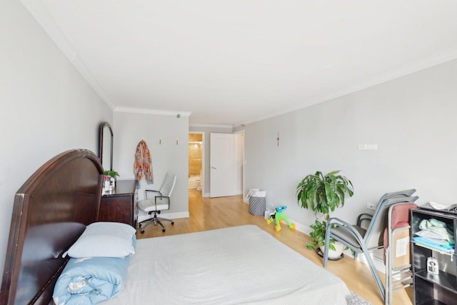 bedroom featuring light wood-type flooring, baseboards, and crown molding