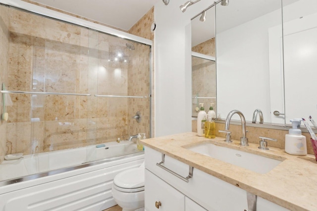 full bath featuring vanity, toilet, and enclosed tub / shower combo