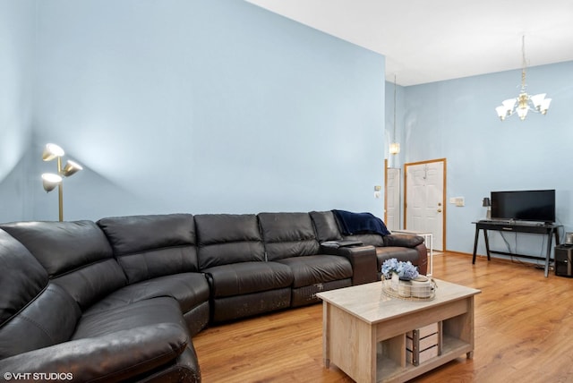 living room with light wood-style flooring and a notable chandelier