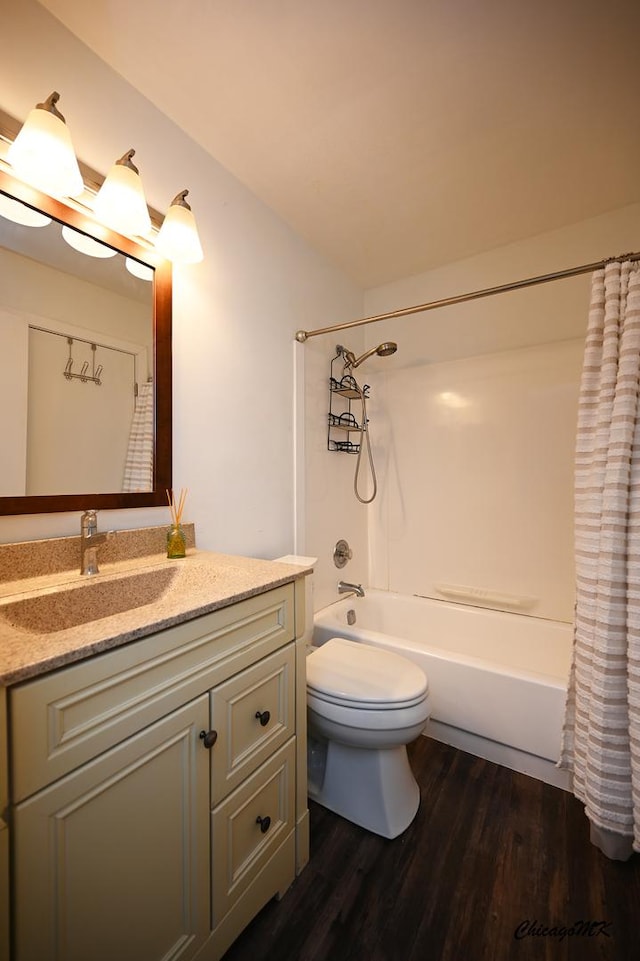 full bath featuring shower / tub combo, vanity, toilet, and wood finished floors