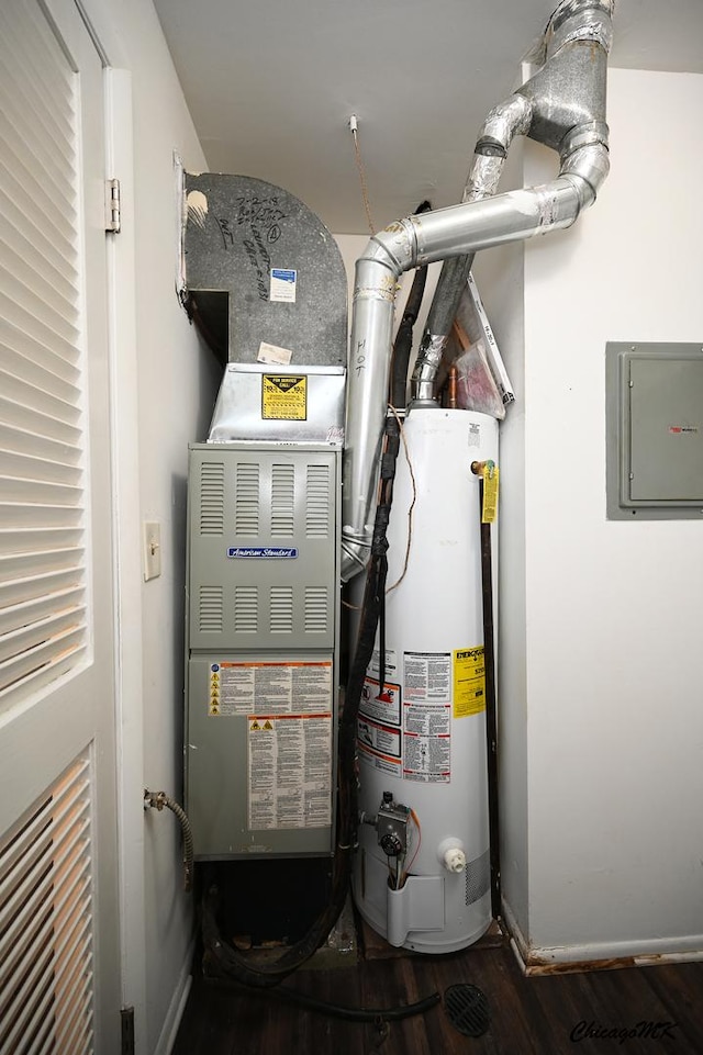 utility room featuring electric panel and water heater