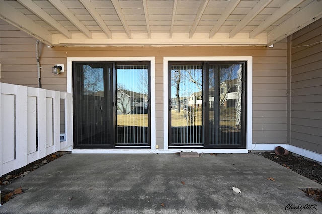 doorway to property with fence and a patio