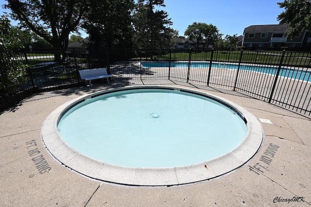 community pool featuring fence