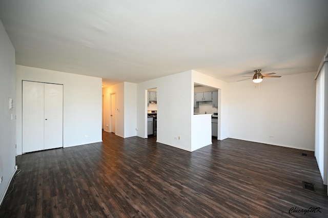 unfurnished living room featuring dark wood-type flooring, visible vents, and a ceiling fan