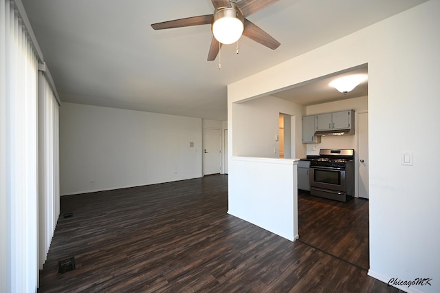 interior space with dark wood-style floors, visible vents, and a ceiling fan