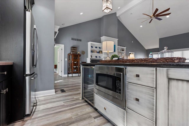 kitchen with a ceiling fan, beverage cooler, visible vents, light wood finished floors, and stainless steel appliances