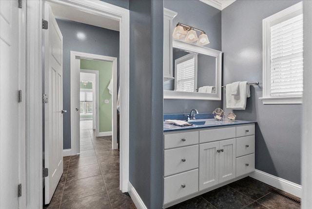 bathroom featuring visible vents, baseboards, vanity, and tile patterned flooring