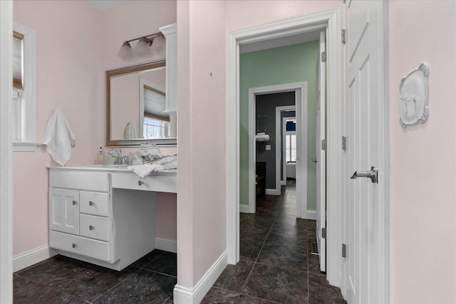 bathroom featuring vanity and baseboards