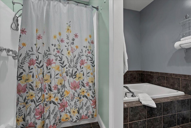 bathroom with a shower with shower curtain and a bath