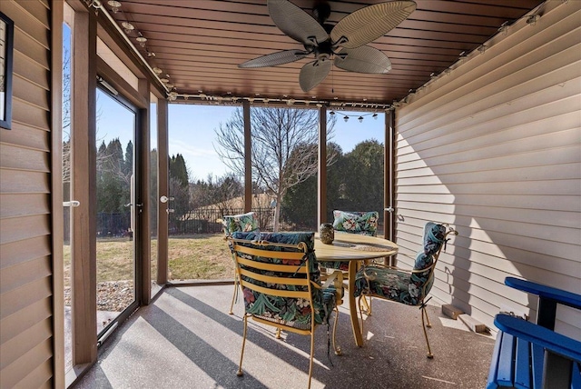 sunroom with a healthy amount of sunlight, ceiling fan, and rail lighting