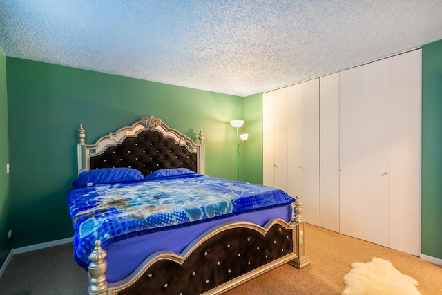 carpeted bedroom with baseboards and a textured ceiling