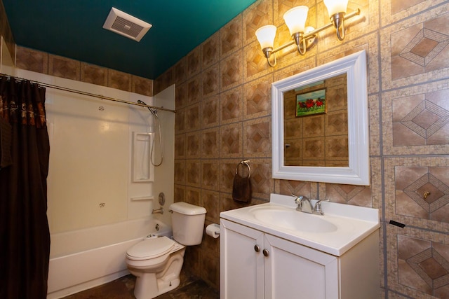 bathroom featuring visible vents, toilet, shower / tub combo with curtain, vanity, and tile walls