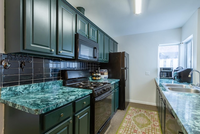 kitchen featuring tasteful backsplash, baseboards, a sink, and black appliances