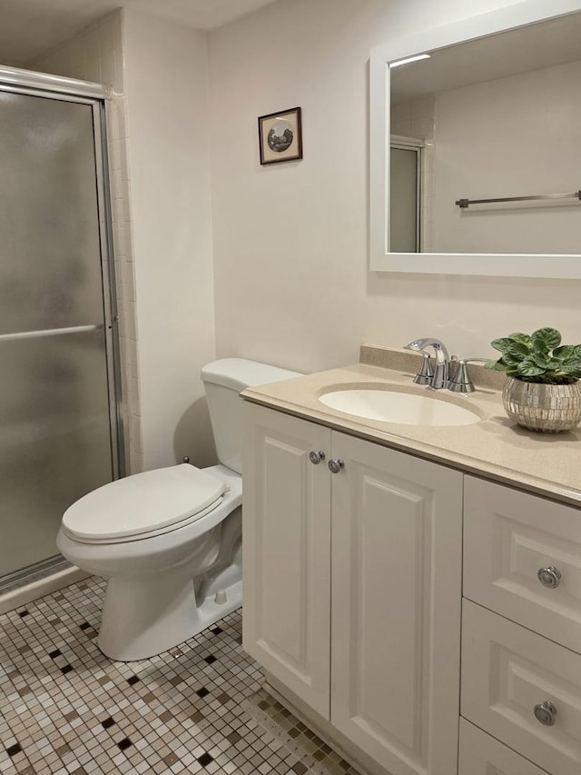 bathroom featuring vanity, tile patterned flooring, a shower stall, and toilet