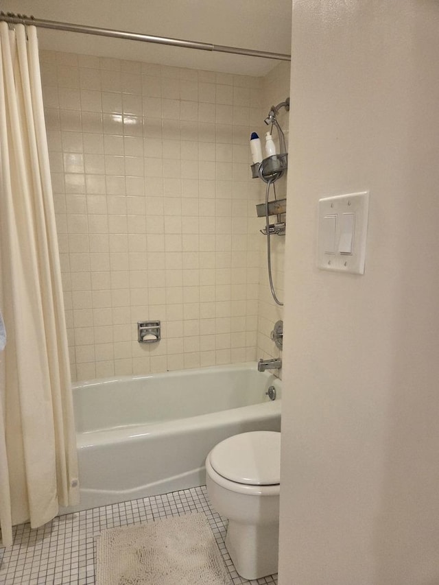 full bath featuring toilet, tile patterned flooring, and shower / bath combo with shower curtain