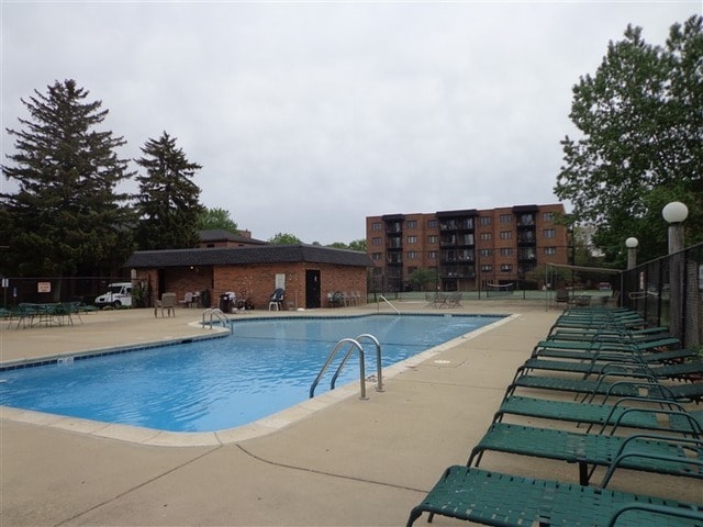 pool featuring fence and a patio