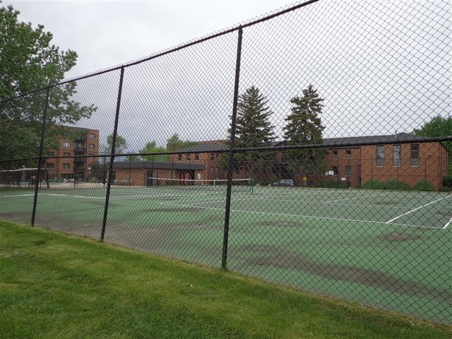 view of tennis court featuring fence