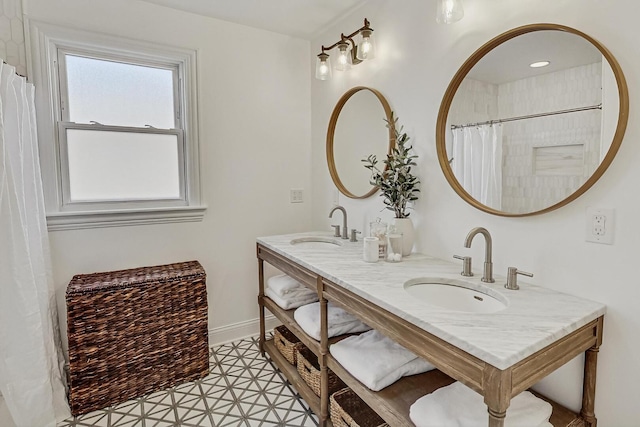 full bathroom with a sink and baseboards