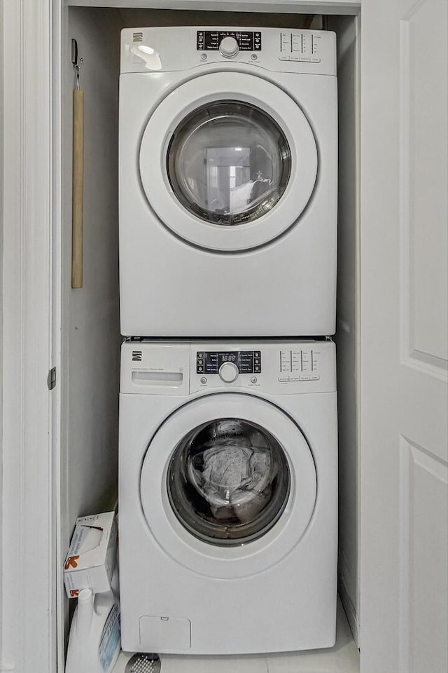 laundry area featuring stacked washer / drying machine and laundry area