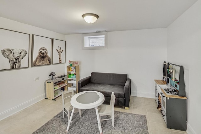 sitting room with light tile patterned floors, visible vents, and baseboards