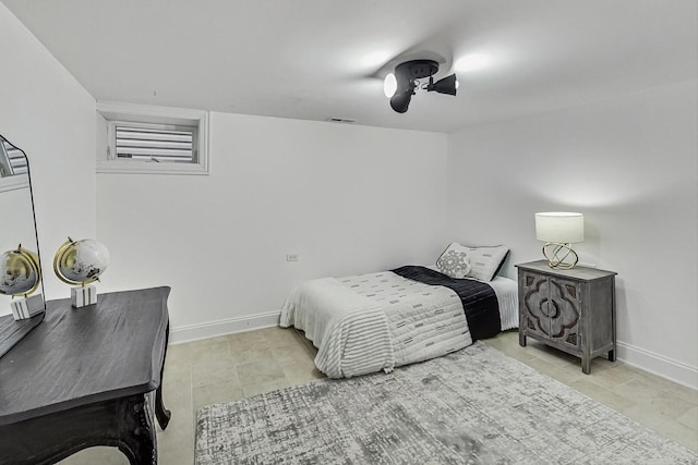 bedroom featuring a ceiling fan, baseboards, and visible vents