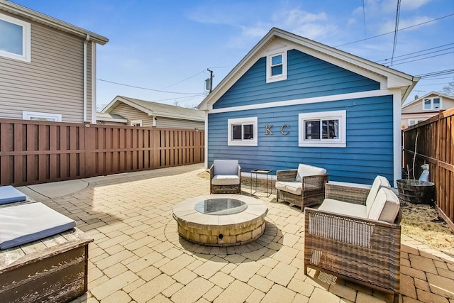 view of patio / terrace with an outdoor living space with a fire pit and a fenced backyard