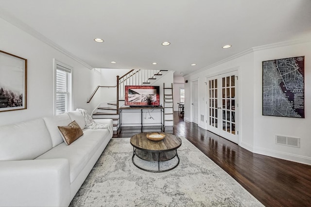 living area with visible vents, a healthy amount of sunlight, french doors, and stairway