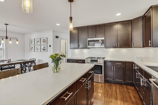 kitchen featuring light countertops, dark brown cabinets, and appliances with stainless steel finishes